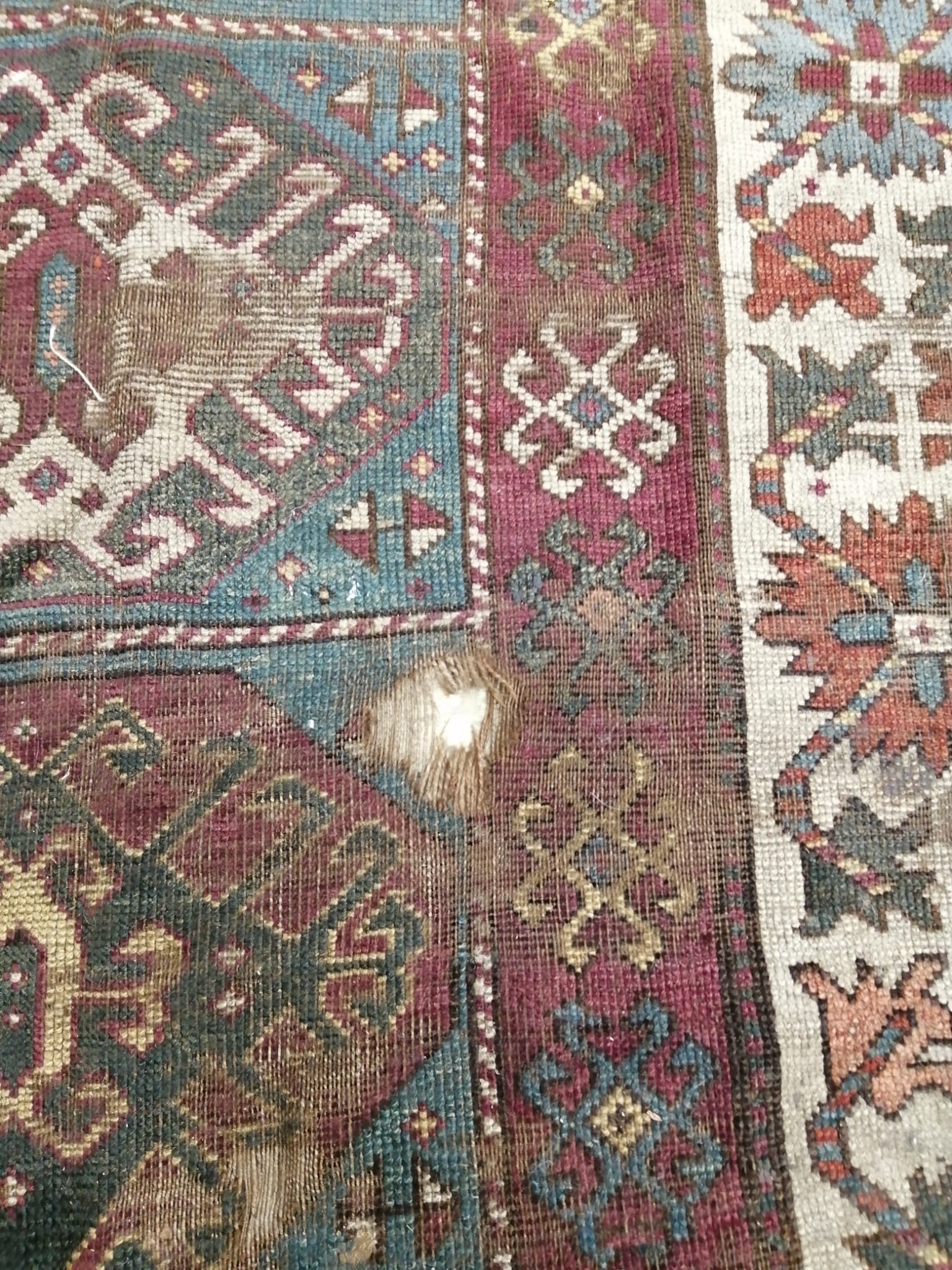 An antique Kazak rug, 310 x 150cm